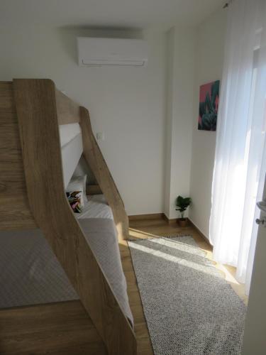 a room with a staircase in a room at Holiday House Maze with jacuzzi in Novalja