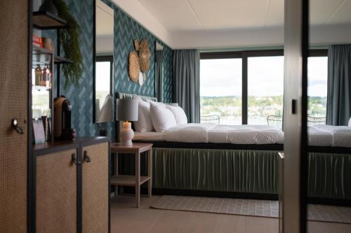a bedroom with a bed and a window at Hotel Riviera in Moss