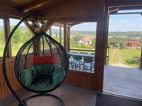 a swing in a screened in porch with a view at Panorama Wine & Chill in Hévíz