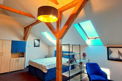 ein Schlafzimmer mit einem Bett in einem Zimmer mit Oberlichtern in der Unterkunft Self Check-In Loft in Klaipeda city centre Free Parking in Klaipėda