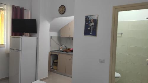 een keuken met een koelkast en een wastafel bij Vila Juna in Ksamil