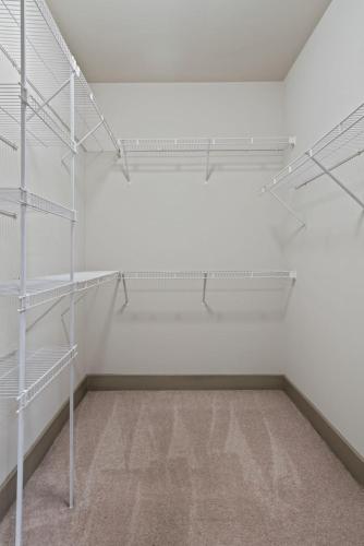an empty room with white shelving at Comfy Retreat Balcony Views Amenities in Woodbridge