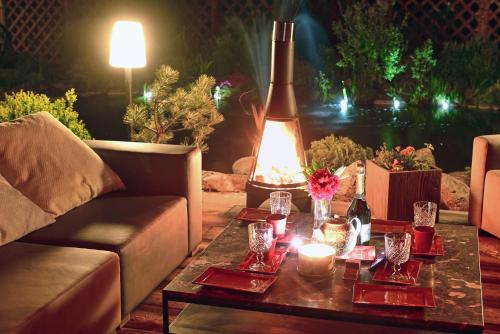 a living room with a couch and a table with candles at Willa Mycyny oraz domki in Mycyny