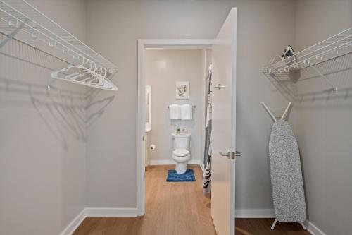 a bathroom with a toilet and a walk in closet at Cityscape Haven Views Close to DC in Arlington