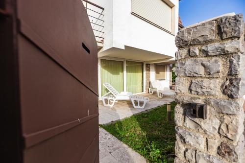 an open door to a house with a stone wall at Casa Summer in Cecina