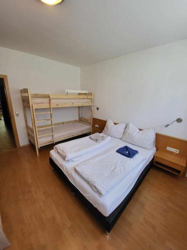 a bedroom with a bed and a wooden floor at Apartment Mölltaler Gletscher 1 in Ausserfragant