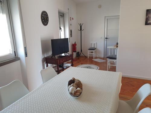 a bowl of nuts sitting on a table in a living room at Casa da Avó Laurinda in Valado dos Frades
