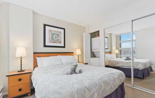 a hotel room with a large bed with a large window at 1BD+Den condo, with free parking in Downtown! in Vancouver