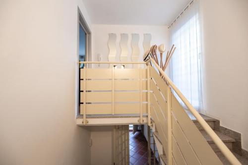 a staircase in a room with white walls and white chairs at Casa Summer in Cecina