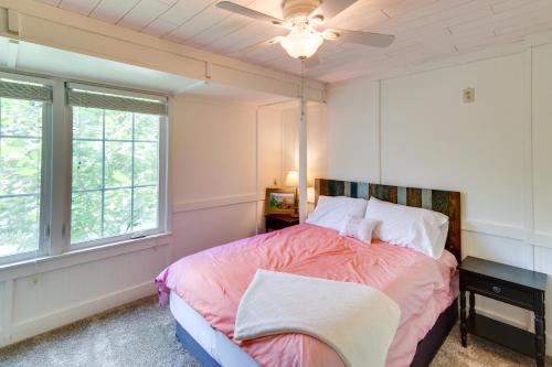 a bedroom with a bed and a ceiling fan at Waterfront Home with Dock Access on Lake Lure! in Lake Lure