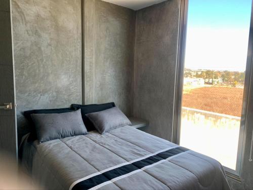 a bedroom with a large bed with a large window at Casa de las mariposas 