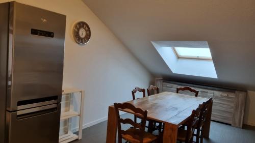 a kitchen with a wooden table and a refrigerator at Appartement T3 60m2 calme in Morez