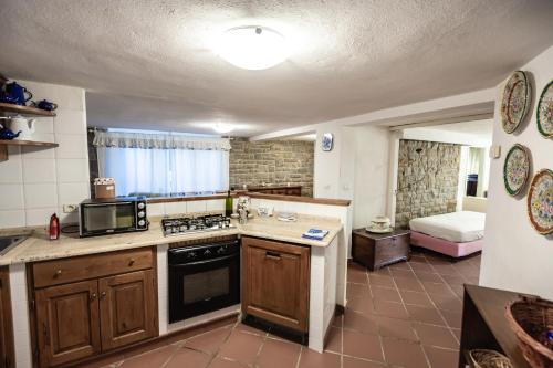 a kitchen with a sink and a stove top oven at Casa Summer in Cecina