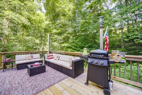 a patio with two couches and a grill on a deck at Fire Pit and Mtn Views North Carolina Abode! in Sylva