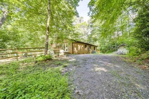 an empty driveway to a house in the woods at Fire Pit and Mtn Views North Carolina Abode! in Sylva