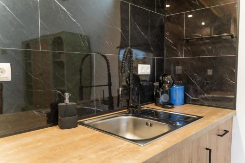 a kitchen with a sink and a counter top at Casa São José in Carvalhal