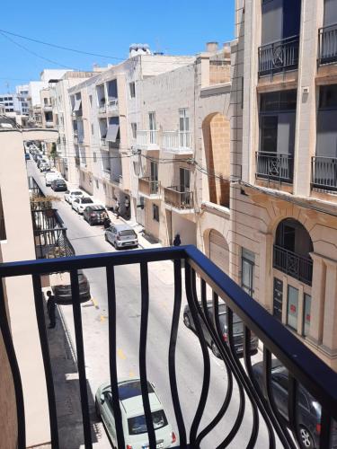 a view of a city street from a balcony at Malta Crown guesthouse in St Julian's