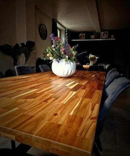 a vase of flowers sitting on top of a wooden table at Le petit Broux in Aywaille