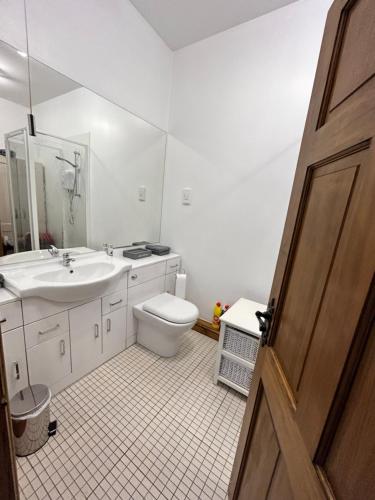a bathroom with a toilet and a sink at Holmleigh Annexe in Tamworth