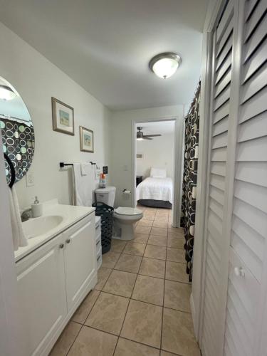 a bathroom with a sink and a toilet and a tub at Guest houses West Palm Beach 2BR or 1BR in West Palm Beach