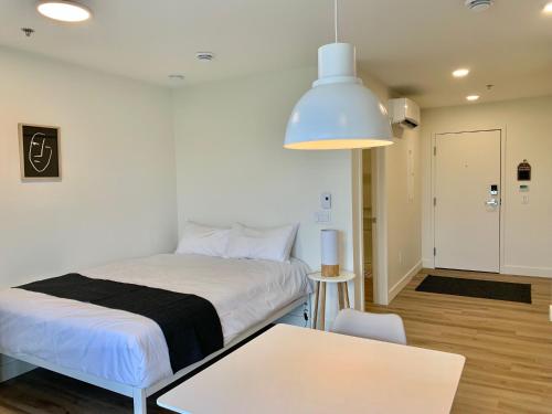 a room with a bed and a table and a room at APPART-HOTEL L'UNI in Quebec City