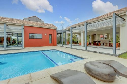a swimming pool in the backyard of a house at Luxurious sandton apartment with Inverter in Sandton