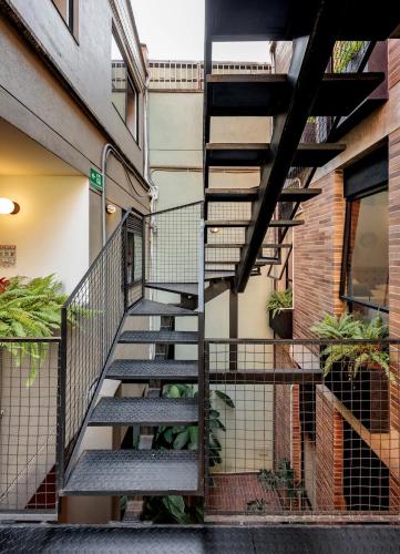 a staircase in the side of a building with plants at The Somos Flats Laureles in Medellín