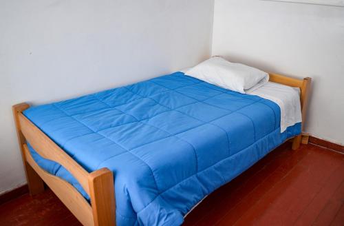 A bed or beds in a room at Peru Hostel Inn Plaza
