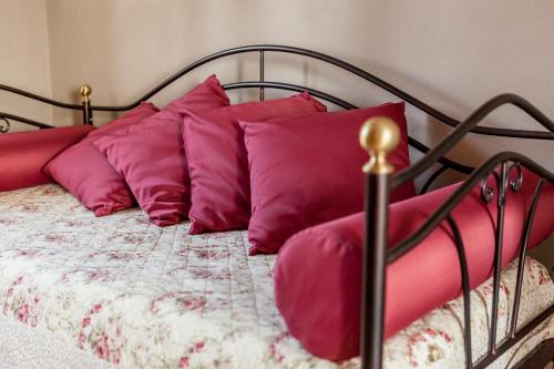 a bed with pink pillows on top of it at Le Bianchette Agriturismo e Fattoria Didattica in Sommacampagna