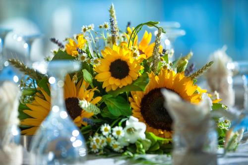 a bouquet of sunflowers sitting on a table at Belvedere Hotel in Kalamata