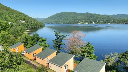 an aerial view of a lake with houses at Knotty Pine Cottages, Suites & Motel Rooms in Ingonish Beach