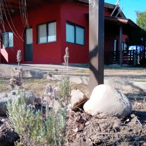 a pile of snow sitting next to a red building at Entre Montañas in Villa Ciudad Parque