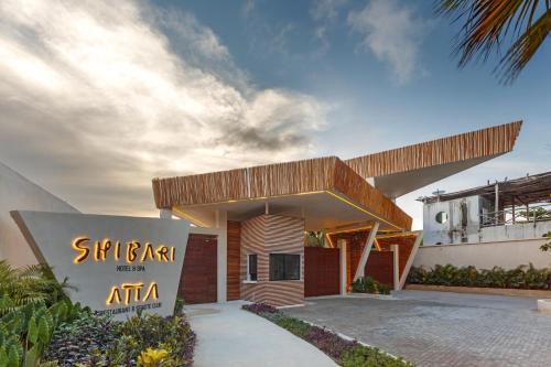 a building with a sign in front of it at Hotel Shibari - Restaurant & Cenote Club in Tulum