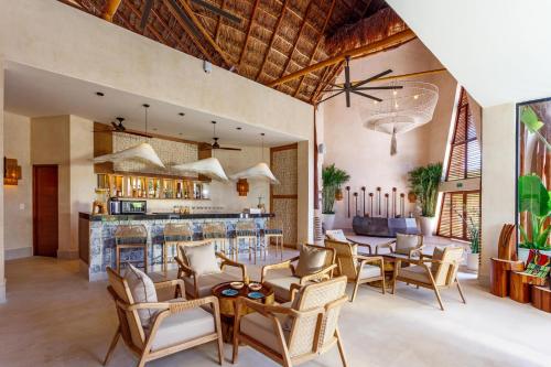an open living room with a table and chairs at Hotel Shibari - Restaurant & Cenote Club in Tulum
