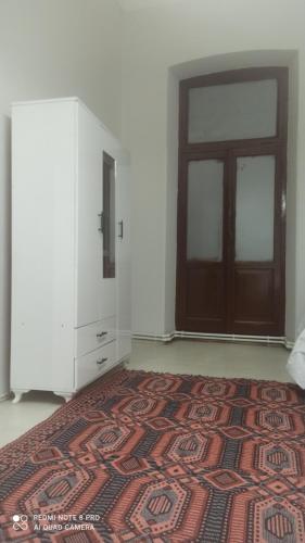 a room with a door and a rug in front of a door at Hamza malikhane (Hane) in Trabzon