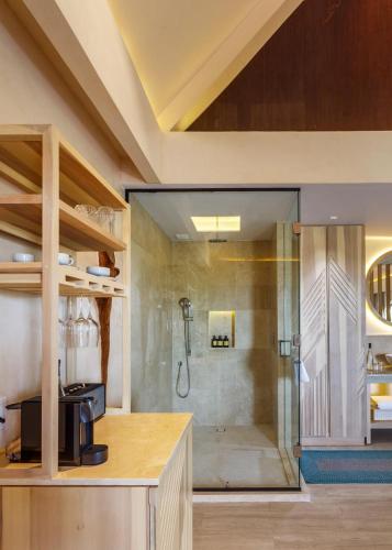 a bathroom with a shower with a glass door at Hotel Shibari - Restaurant & Cenote Club in Tulum