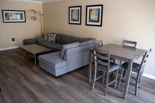 a living room with a couch and a table at Travelodge by Wyndham Monterey Bay in Monterey
