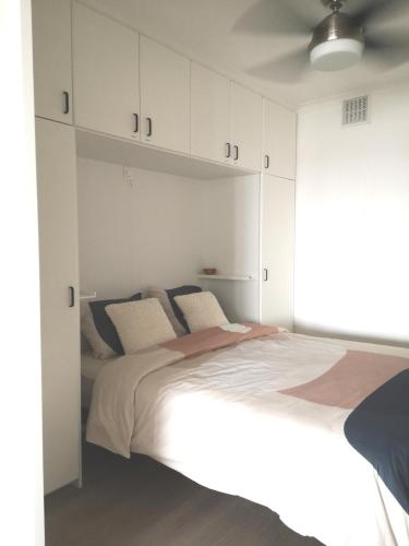 a bedroom with a large bed with white cabinets at Westeinders Sea View in Middelkerke