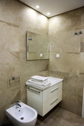 a bathroom with a sink and a toilet and a mirror at Lisbon Tagus River - Almada in Almada