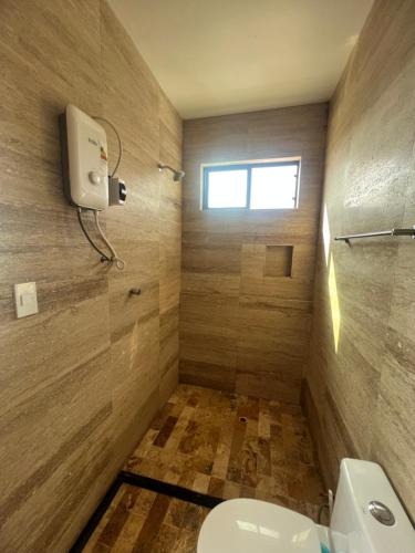 a bathroom with a toilet and a shower at Casablanca del Mar in Punta Hermosa