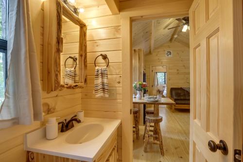 a bathroom with a sink in a log cabin at Mtn-View Middlebury Center Cabin Deck and Grill! in Middlebury Center