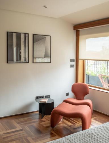 a living room with a chair and a table at The Passage Apartments in Donostia-San Sebastián