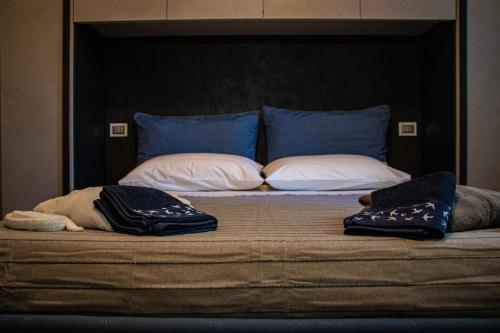 a bed with two pillows on top of it at Selva Castalda in Tuscania