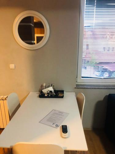 a white table in a room with a mirror at Center lux Apartments in Bitola