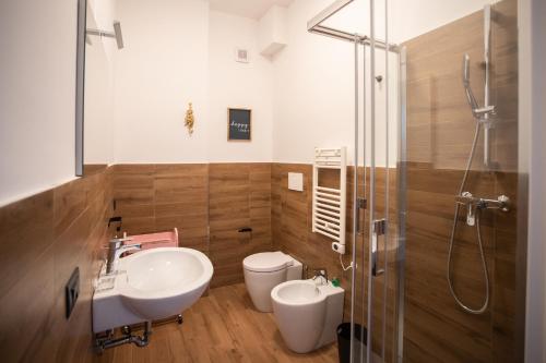 a bathroom with a sink and a toilet and a shower at Joya Apartment's - Milazzo in Milazzo