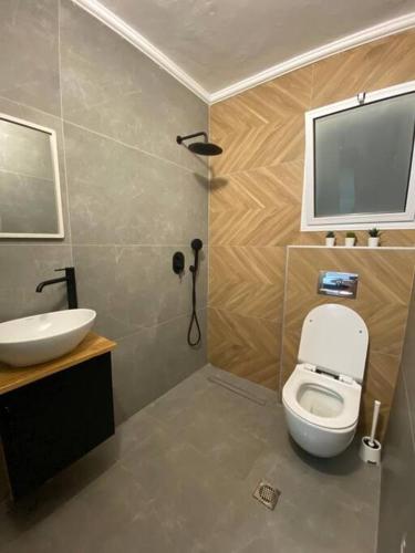 a bathroom with a white toilet and a sink at מצפה הכינרת in Safed