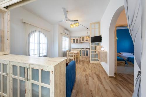a kitchen and living room with white walls and wood floors at Dahab One - El Primo VIP apartments in Dahab