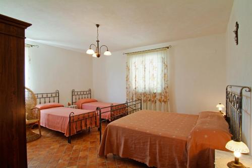 a bedroom with two beds and a chandelier at Agriturismo Il Tratturo in Pescara
