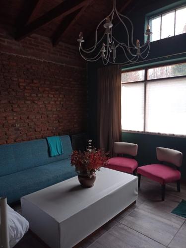 a living room with a couch and a table at "Donde brilla el sol" Casa Campo in Dina Huapi