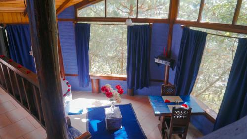 an aerial view of a living room with blue curtains at Destinos Exclusivos Patate in Patate